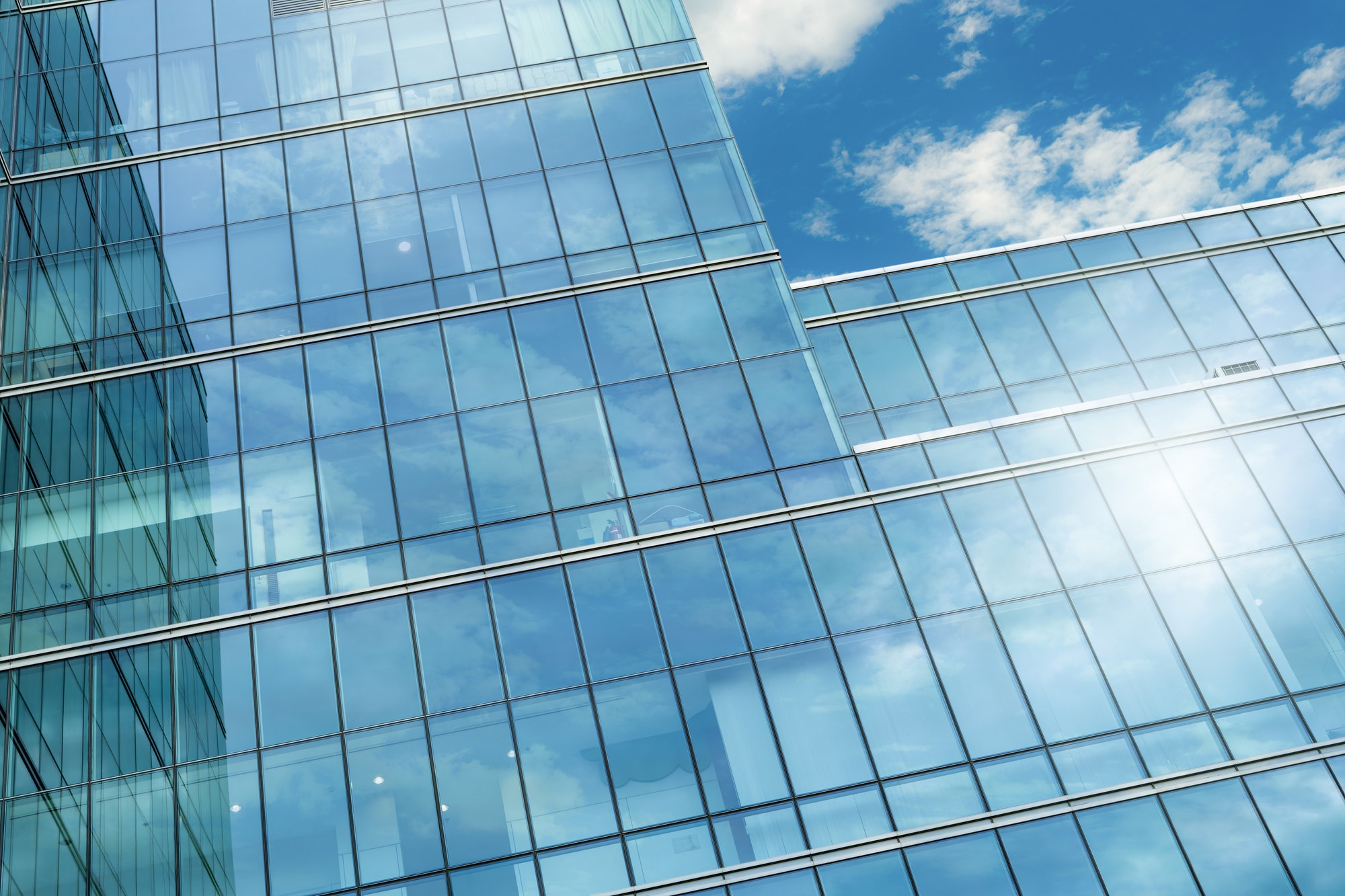 Modern sustainable glass office building. Exterior view of corporate headquarters glass building