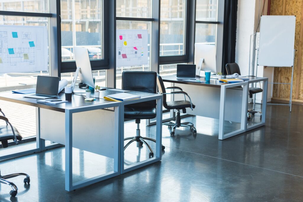 working tables with computers and laptops in business office